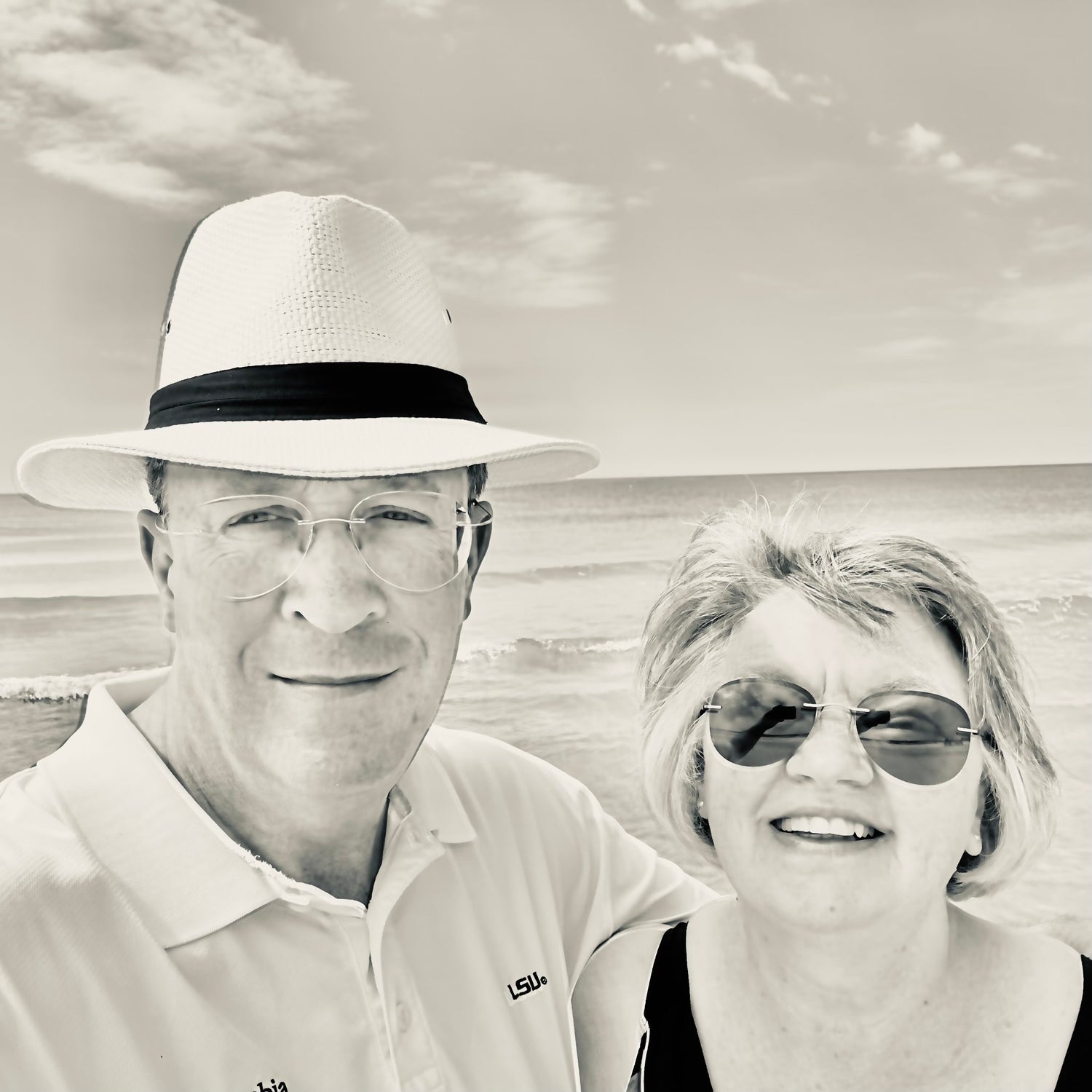 Black and white photo of a married couple, a man and woman, at a beach