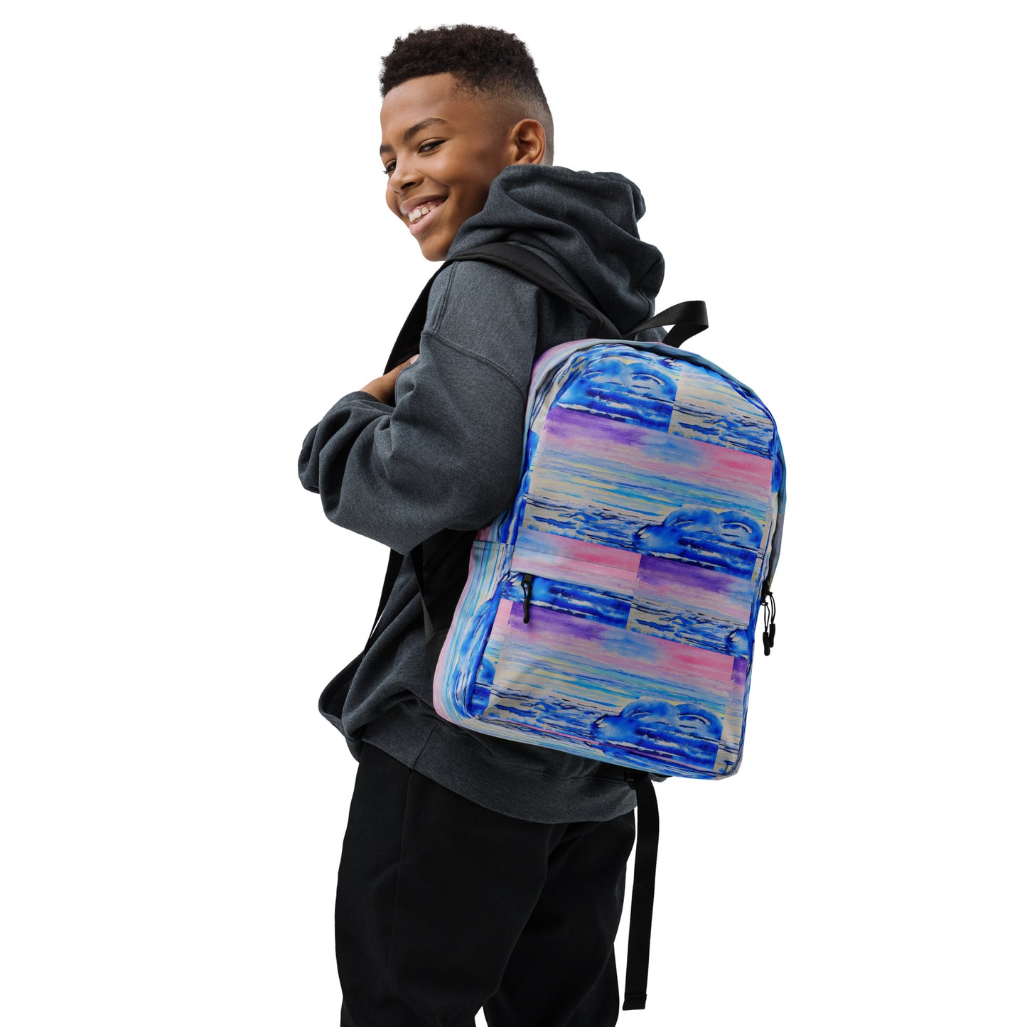 African American boy wearing a colorful backpack with waves on it with a white background