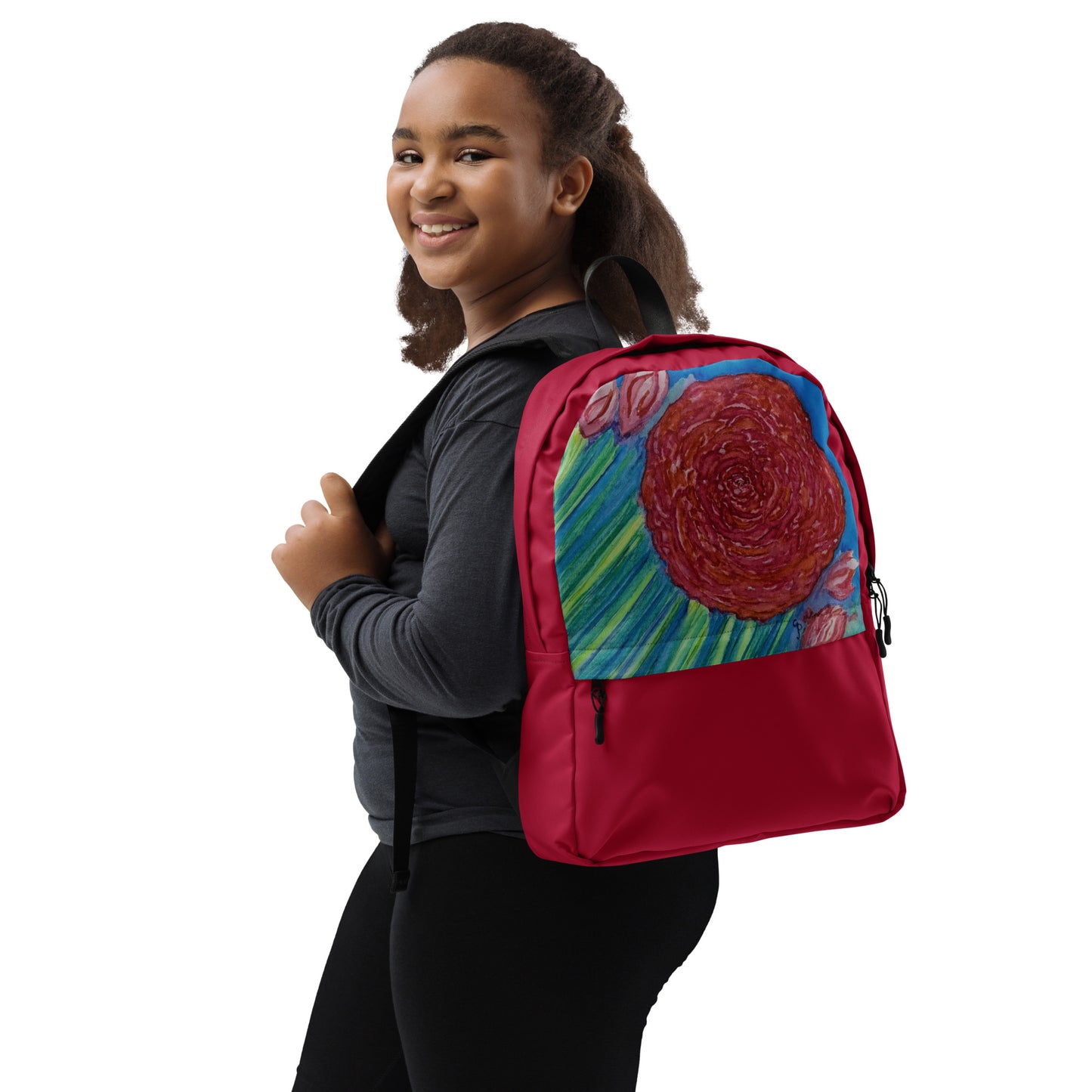 African American girl wearing a red backpack with an original floral design on it