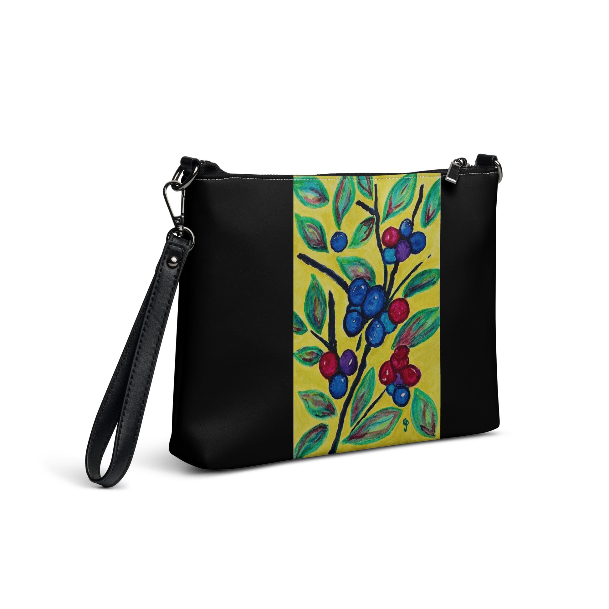 Black handbag with a colorful floral design on a yellow background