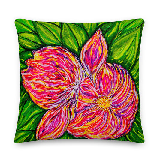 Decorative pillow with a vibrant pink flower design on a green leaf background