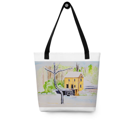 Tote bag with a winter scene featuring a yellow house and trees