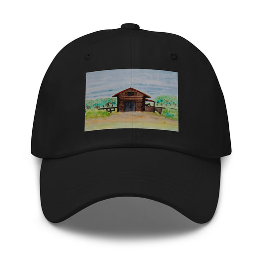 Black cap with a wooden barn and farm illustration on a white background