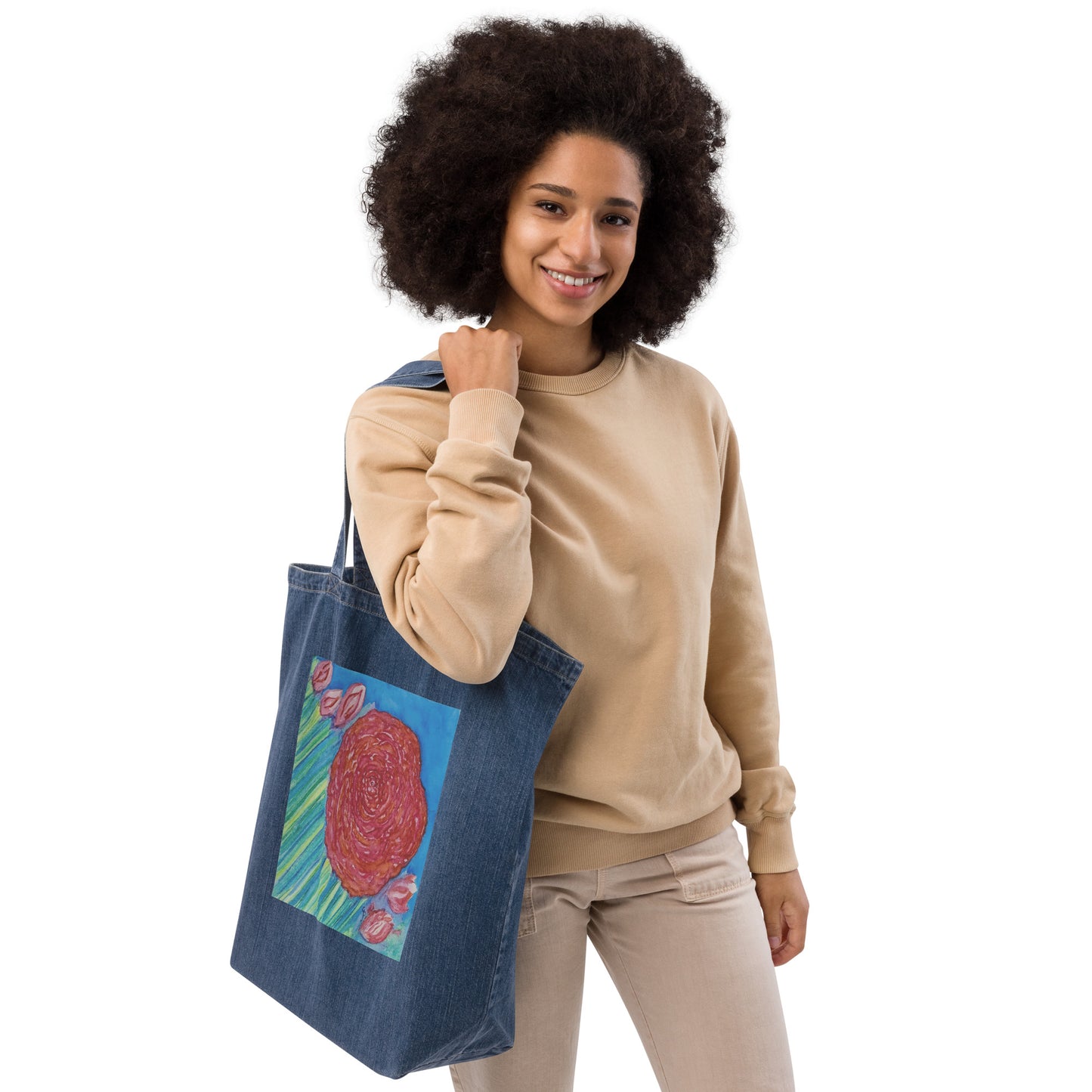 African American woman holding a blue denim tote bag with a colorful original artwork design