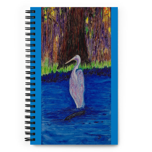 Notebook with a painting of a heron in a pond on the cover