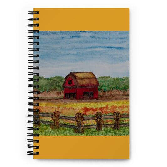 Notebook with a red barn illustration on a yellow background