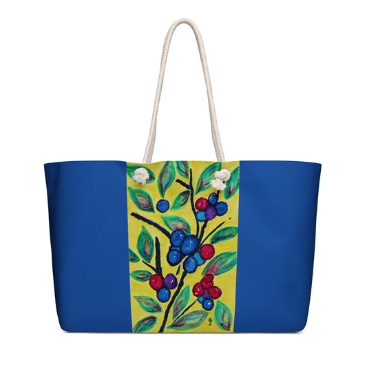 Tote bag with blue base and colorful floral design on a white background
