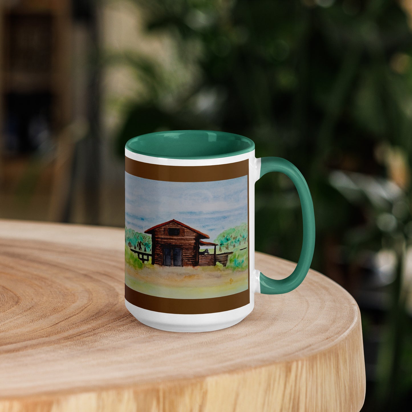 Mug with a manly scenic design of a wooden barn on a wooden surface with a blurred natural background