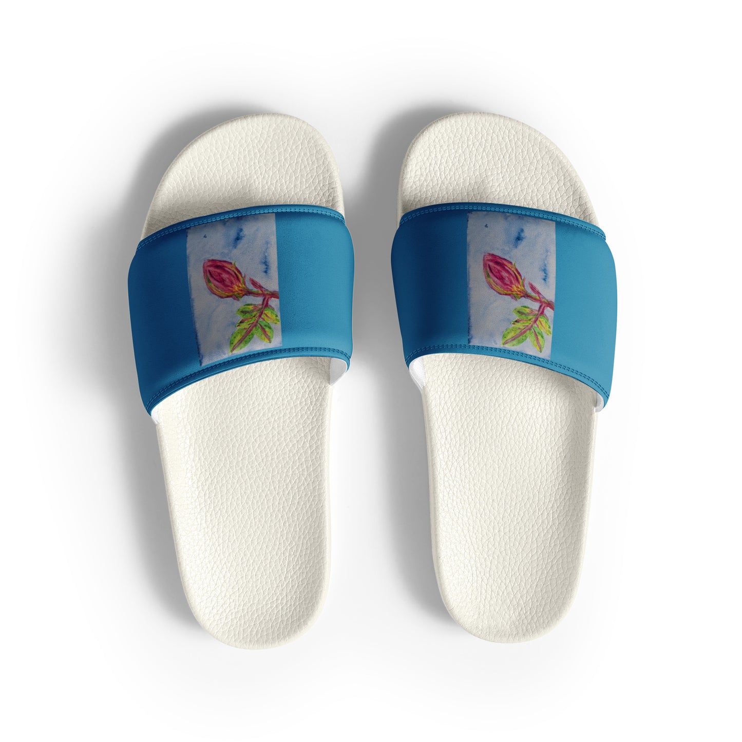 Pair of white slippers with blue bands featuring floral designs on a white background