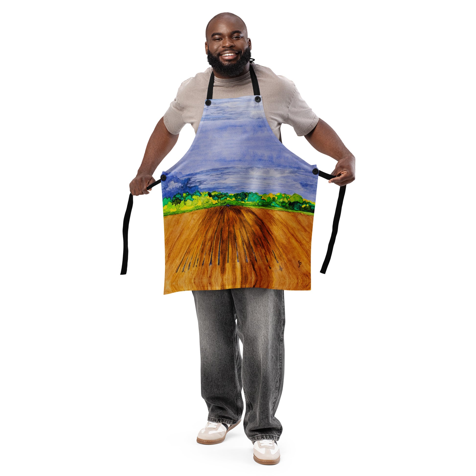 African American man wearing a colorful apron with a landscape design on a white background