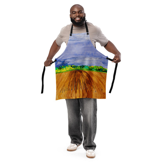African American man wearing a colorful apron with a landscape design on a white background