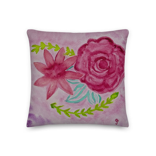 Decorative pillow with pink flowers and green leaves on a light pink background
