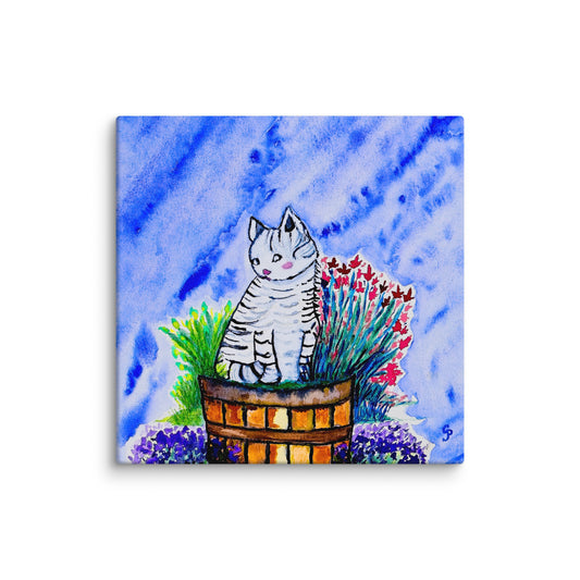 Canvas print with a cat sitting in a basket of flowers against a blue watercolor background
