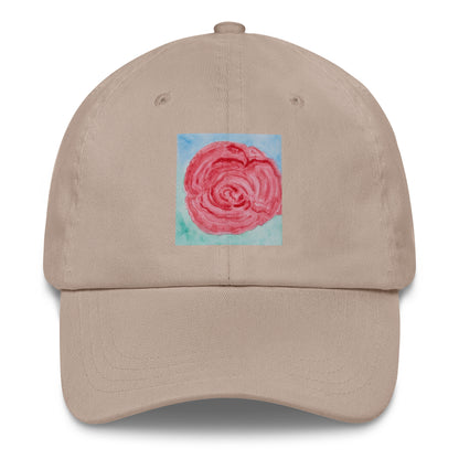 Beige cap with a pink rose design on a blue background