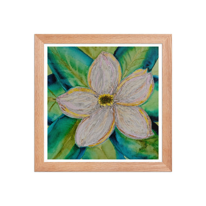 Framed artwork of a magnolia flower on a bed of blue green leaves