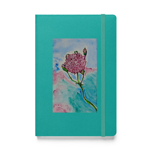 Teal notebook with a floral design on a white background
