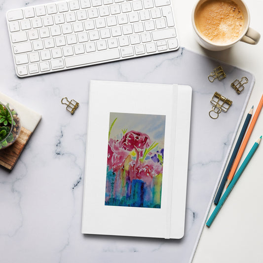 Colorful floral notebook on a tablet with office supplies on a marble desk
