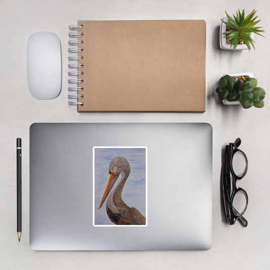 Laptop with a pelican sticker on a desk with a notebook, mouse, and plants.