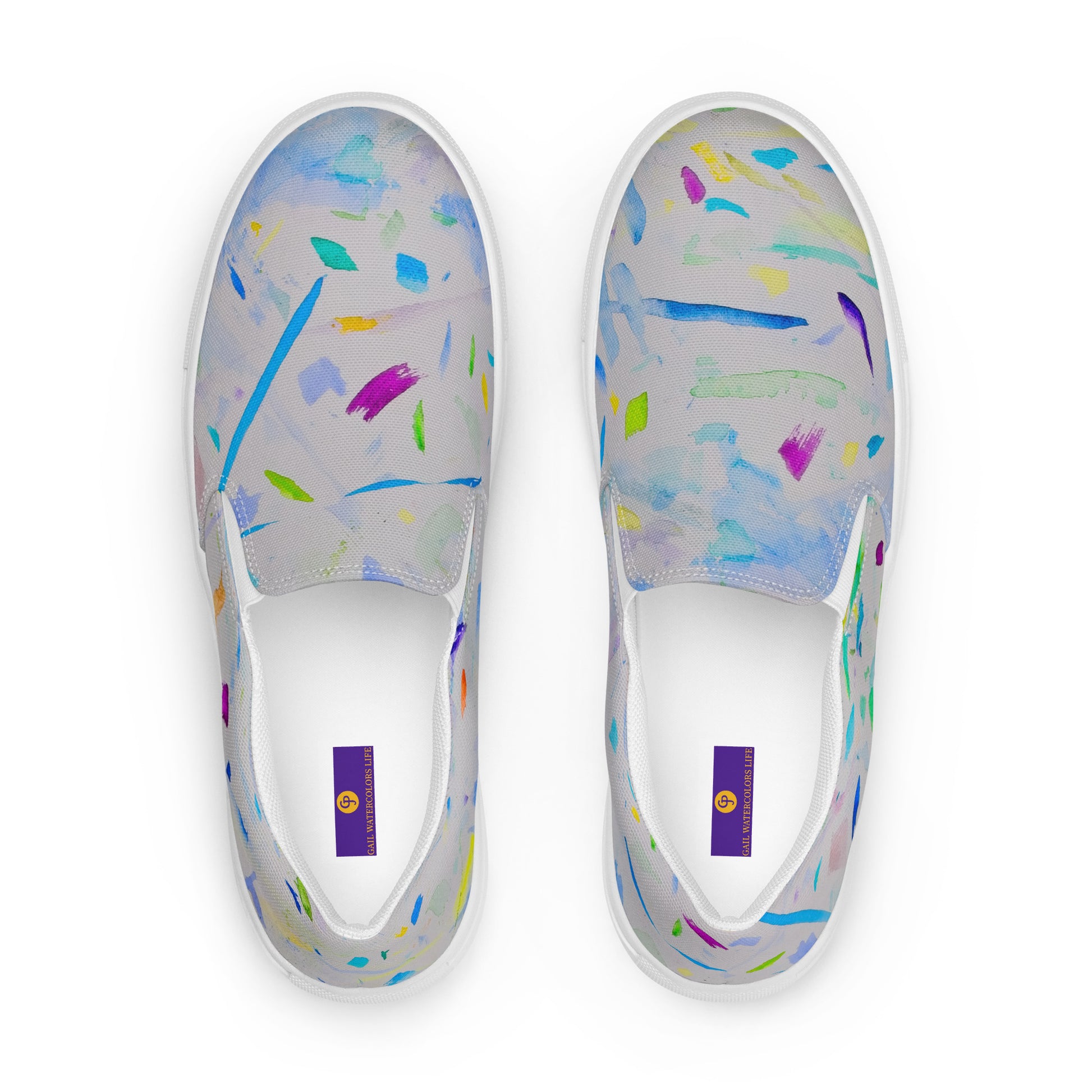White slip-on shoes with colorful abstract pattern on a white background
