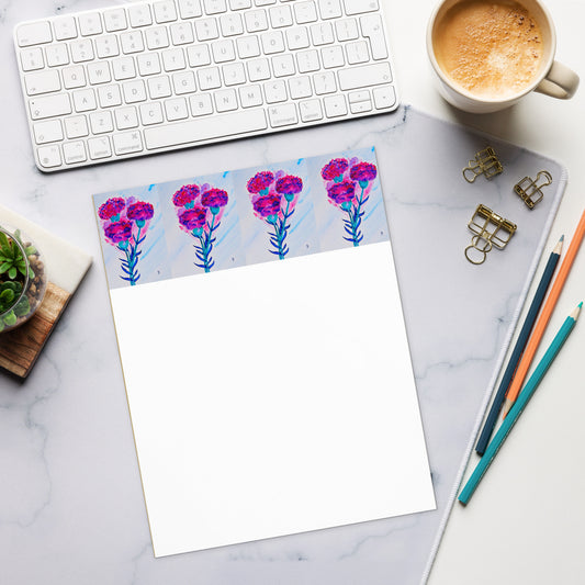 Floral notepad on a marble desk with office supplies