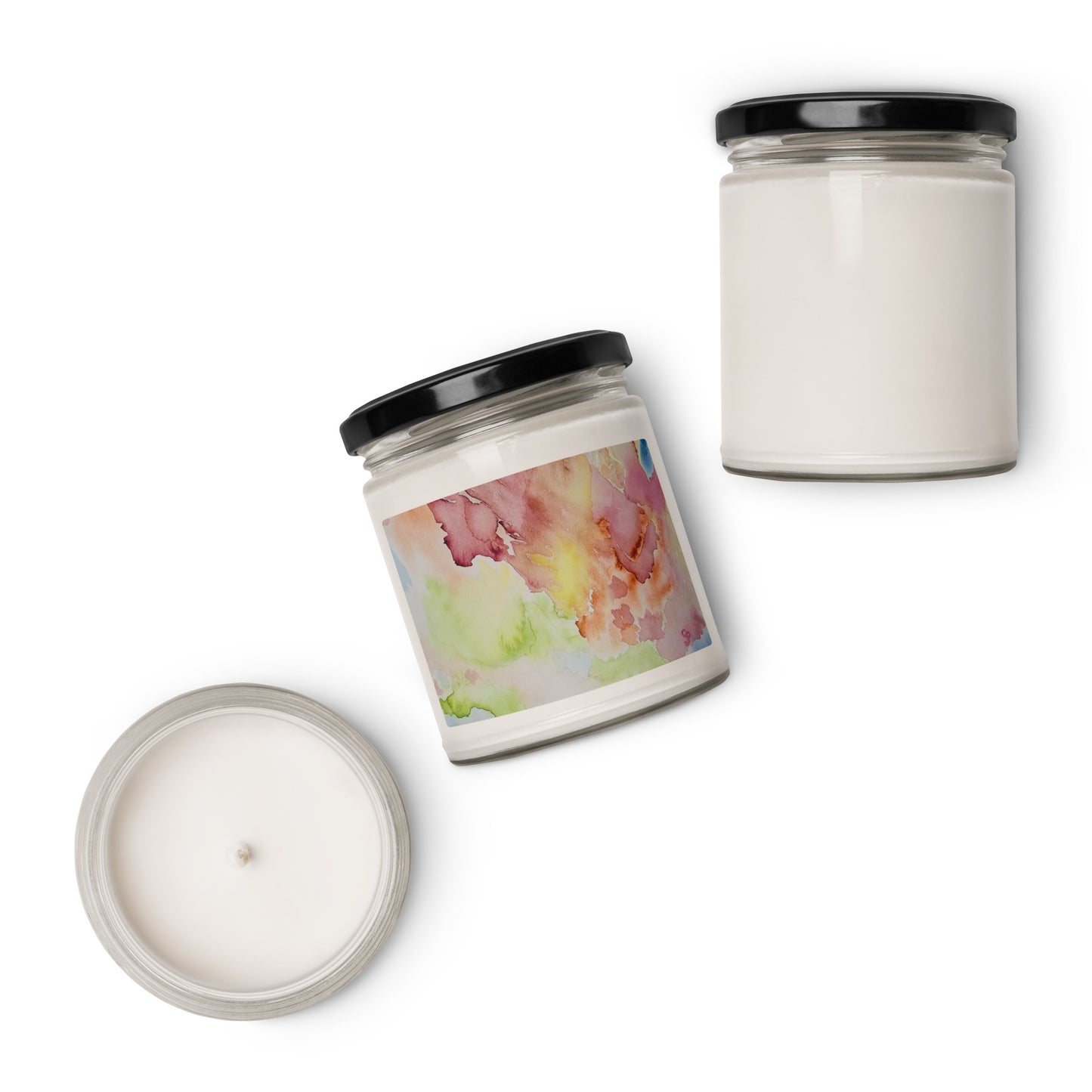 Two candles with black lids on a white background