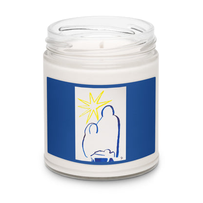 Candle in a jar with a blue label featuring a stylistic outline of the nativity family and the yellow star 