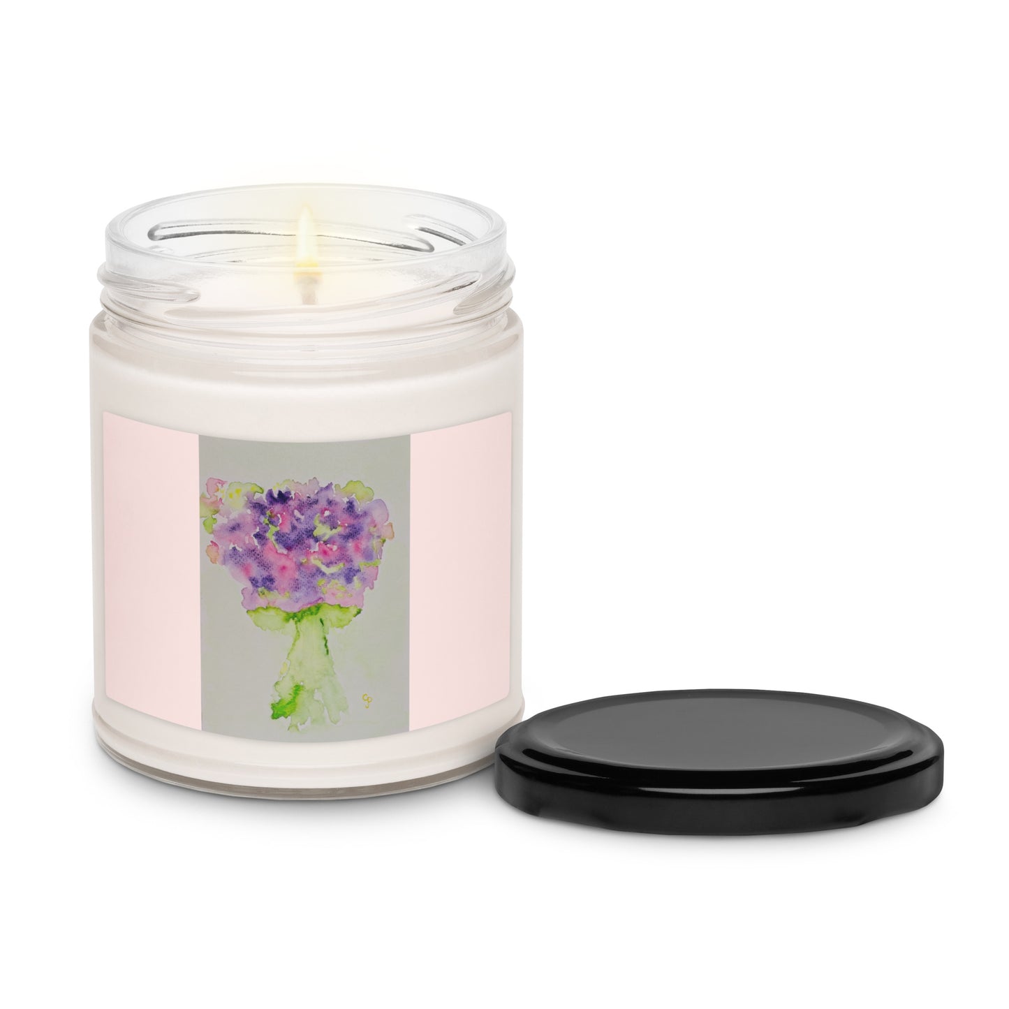 Candle in a glass jar with a floral label on a white background