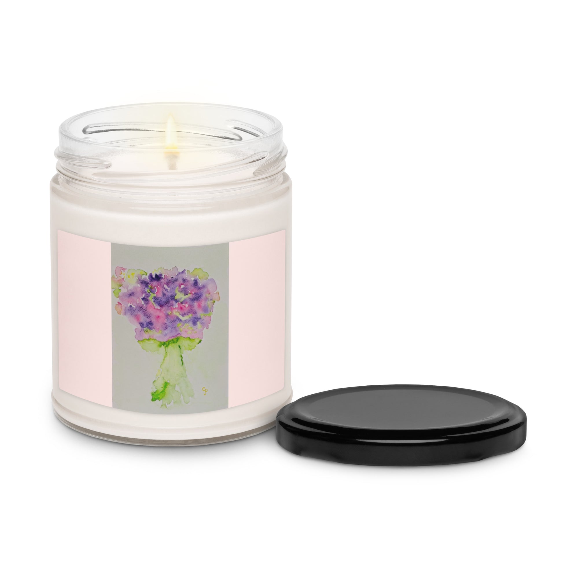 Candle in a glass jar with a floral label on a white background