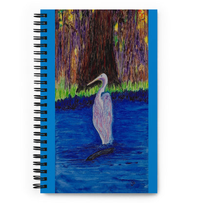 Notebook with a painting of a heron in a pond on the cover