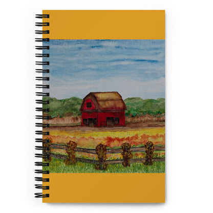 Notebook with a red barn illustration on a yellow background
