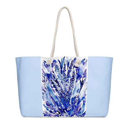 Tote bag with blue floral design on a light blue background