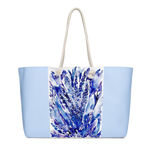 Tote bag with blue floral design on a light blue background