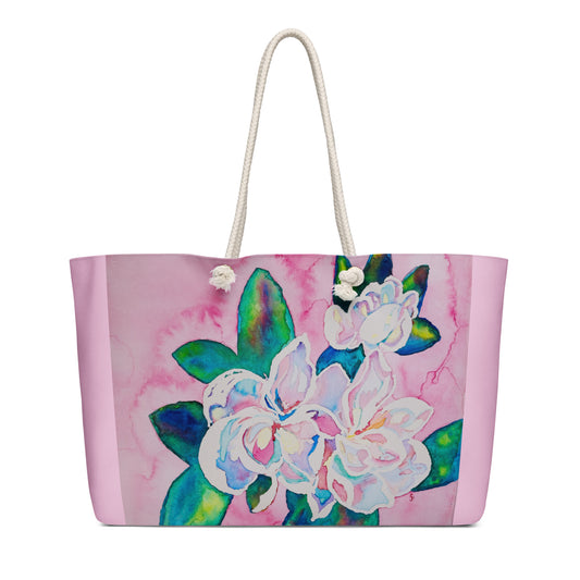 Tote bag with floral watercolor art design on a pink background