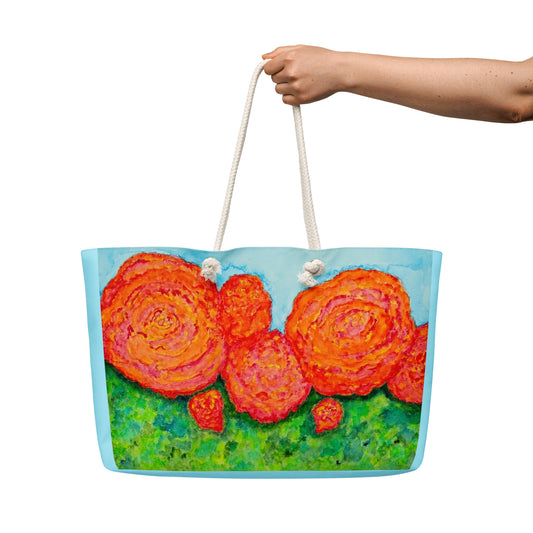 Tote bag with floral design held by a hand on a white background