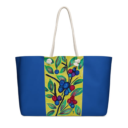 Tote bag with blue base and colorful floral design on a white background